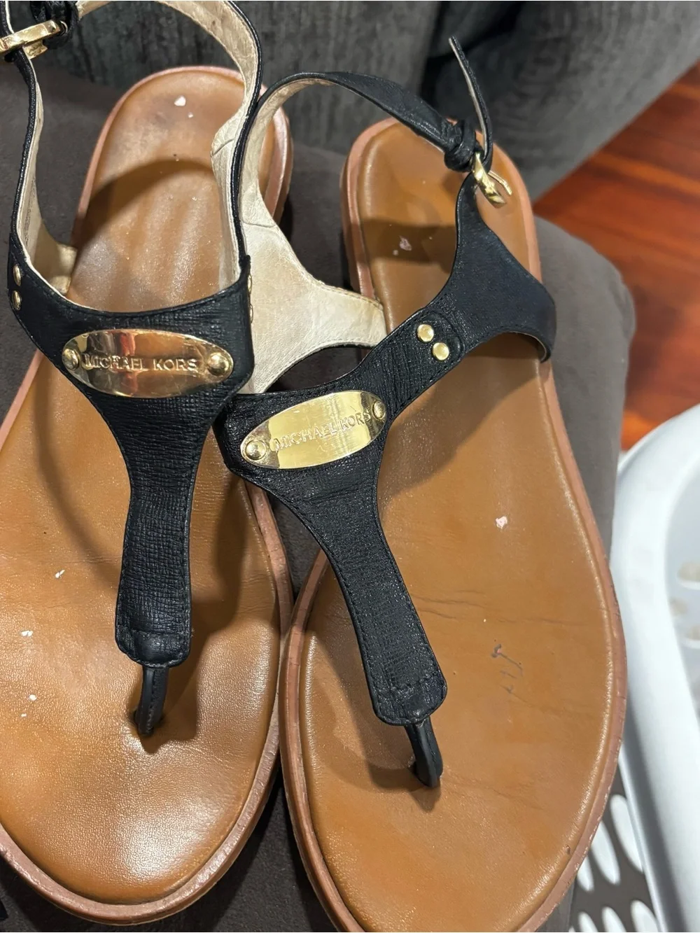 Michael Kors Black and Tan Leather T-Strap Sandals with Gold Plaques